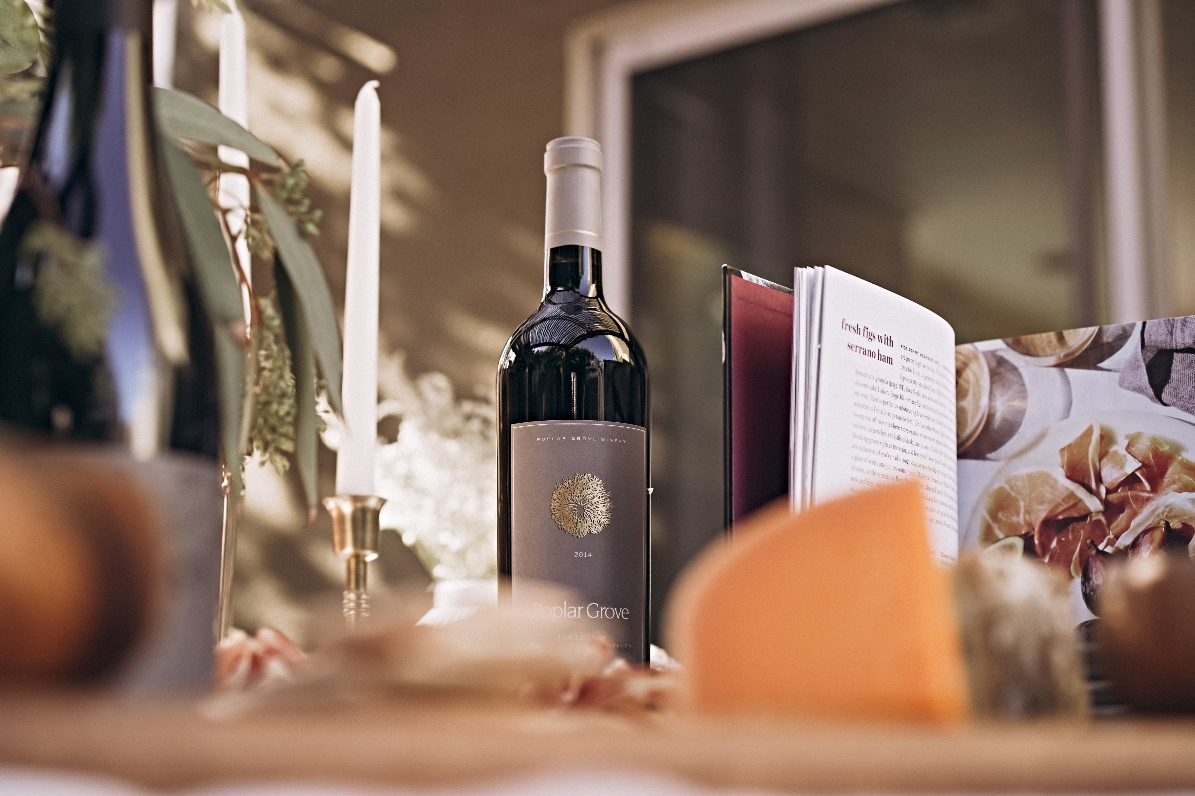Wine gift bundles on a candlelit holiday table